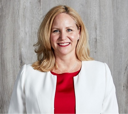 AUSTRAC CEO Nicole Rose standing face on wearing a white jacket over a red blouse